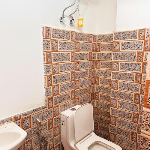 a bathroom with a toilet and a sink at Hotel Kiara In Shillong in Shillong