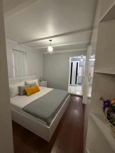 a white bedroom with a bed and a window at Manika Grigoleti in Grigoleti