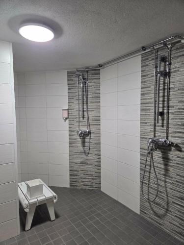 a bathroom with a shower and a bench in it at Leinosen Lempi in Ylämylly
