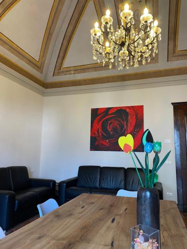 a dining room with a table and a chandelier at Once upon a time in Domaso