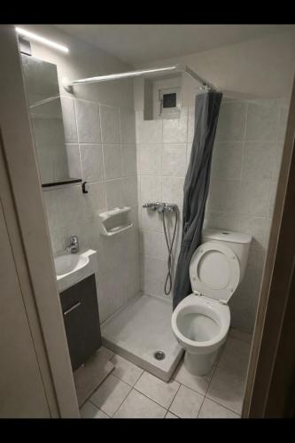 a small bathroom with a toilet and a sink at Kathryns apartment in Sinarádes