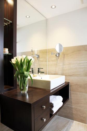 a bathroom with a sink and a mirror at CITY STAY - Kieselgasse in Zurich
