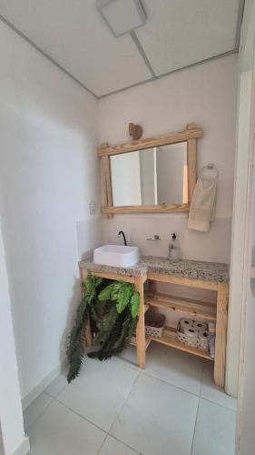 a bathroom with a sink and a mirror at Refúgio da Lagoa de Araruama - AP 202 in Araruama