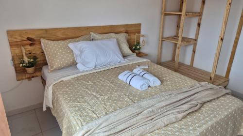 a bedroom with a bed with two towels on it at Refúgio da Lagoa de Araruama - AP 202 in Araruama