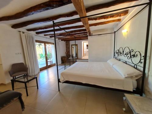 a bedroom with a large bed with a metal frame at Morna valley in Sant Carles de Peralta