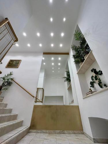 a hallway with stairs and potted plants on the walls at Golden Residence in Vienna