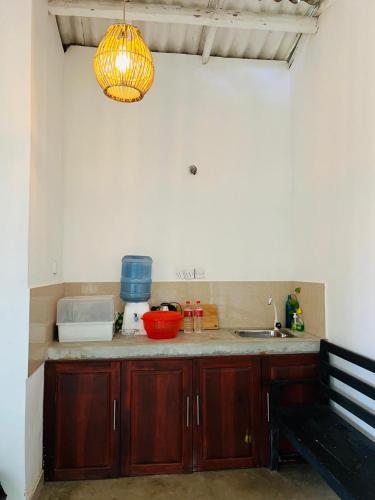 a kitchen with a counter with a sink and a bench at Lagoon Home Stay in Ahangama