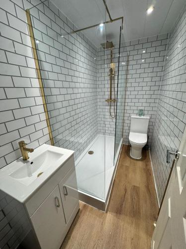a bathroom with a shower and a sink and a toilet at The Lang Toun Bothy - close to Edinburgh by Urban Haggis Stays in Kirkcaldy