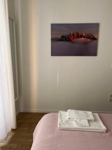 a bedroom with a bed with a towel on it at Al Monte Zelo in Agordo
