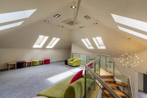 an attic with skylights and stairs in a room at Kings Court Hotel Alcester, BW Signature Collection in Stratford-upon-Avon
