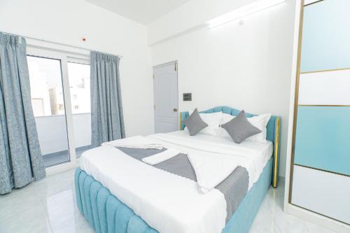 a bedroom with a large bed with a mirror at Aikya Service Apartment in Hyderabad