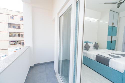 a bedroom with a bed and a mirror at Aikya Service Apartment in Hyderabad