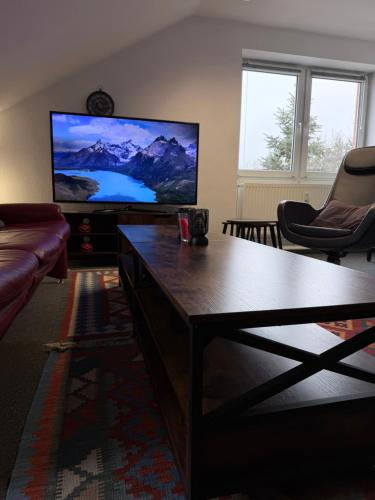 a living room with a large flat screen tv at Gemütliches City-Appartment in Wentorf bei Hamburg