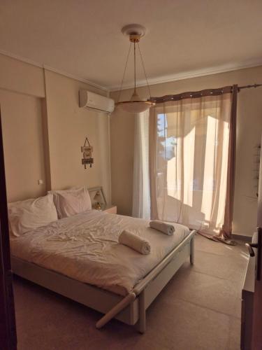 a bedroom with a bed with two towels on it at Sea View Artaki Apartment in Nea Artaki