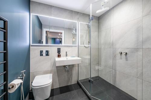 a bathroom with a sink and a toilet and a shower at Stylish Flat next2 Wimbledon with a parking in Mitcham Junction