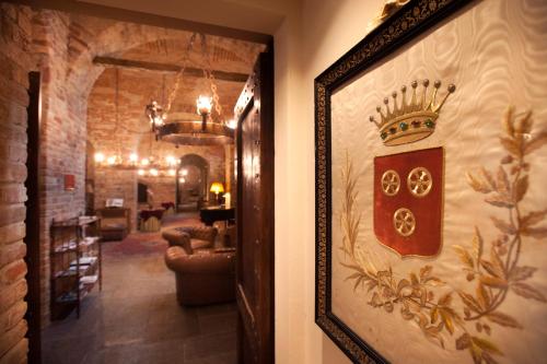 a door with a picture of a crown on the wall at Castello di Guarene in Guarene