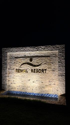 a sign for a renault network on a brick wall at Remal Resort Bidiyah in Badīyah