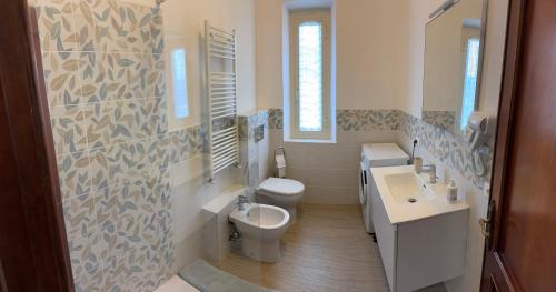 a bathroom with a toilet and a sink and a mirror at Cà Turi Sarzana in Sarzana