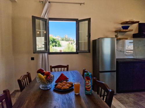 a kitchen with a table with a bowl of fruit on it at family MARIA in Kalymnos