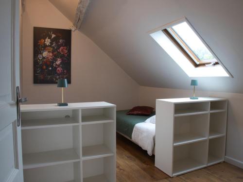 a attic bedroom with a bed and a skylight at Cottage l'Orée du Cher in Chissay-en-Touraine