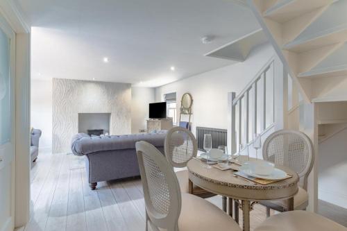 a living room with a table and chairs and a couch at 1 Bed in Holt oc-1854 in Holt