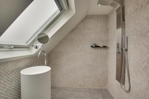 a bathroom with a shower and a skylight at 1 Bed in Holt oc-1854 in Holt
