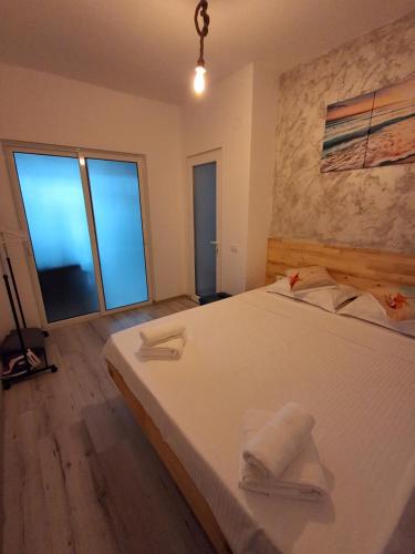 a bedroom with a large bed with two towels on it at Apartament DelyMar in Agigea