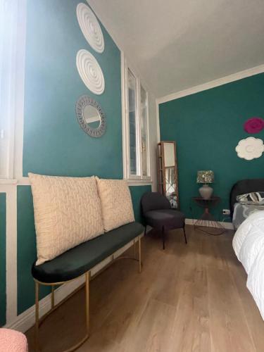 a bedroom with a couch and a blue wall at San Clemente guest house in Padova