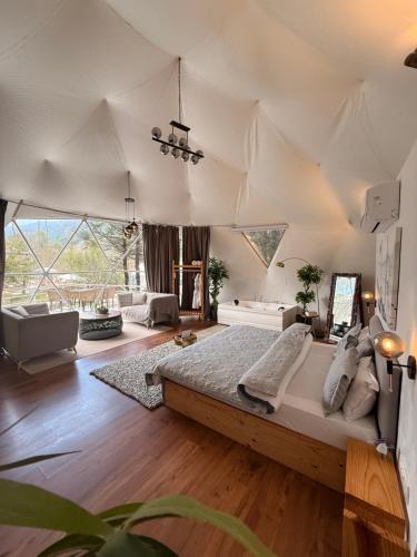 a bedroom with a large bed in a tent at The GlampView Resort in Manāli