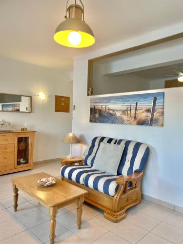a living room with a couch and a table at Bayview Apartment 106 in Albufeira