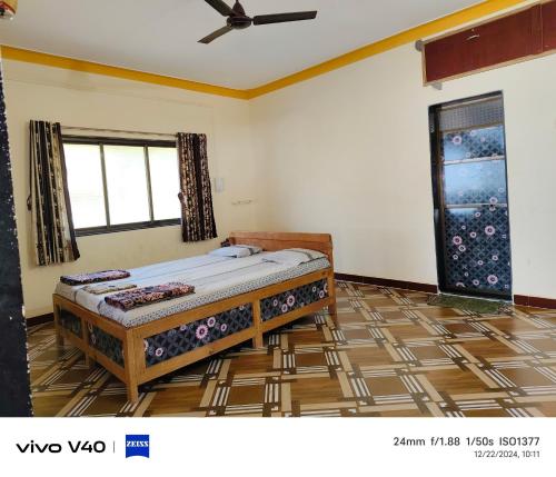 a bedroom with a bed in the corner of a room at Silver sand beach resort in Malvan