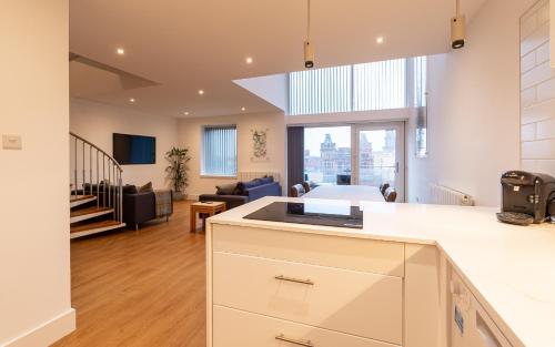 an open kitchen and living room with a large window at CITY CENTRE APARTMENT with Free Secure Underground Parking in Glasgow