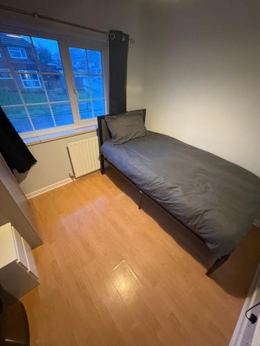 a bedroom with a bed in the corner of a room at Cosy room 6 T Gatwick in Crawley
