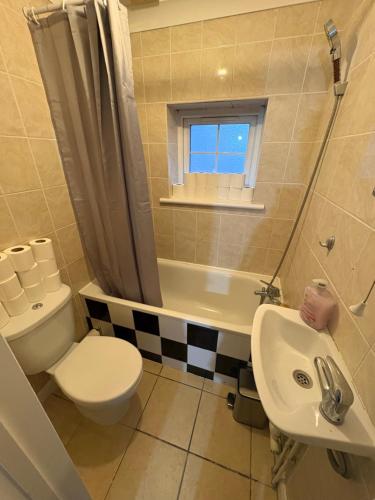 a bathroom with a white toilet and a sink at Cosy room 6 T Gatwick in Crawley