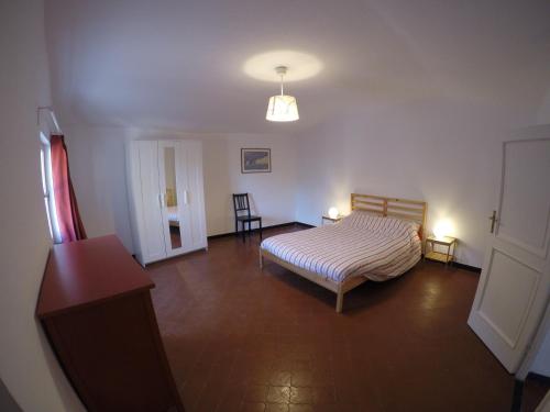 a bedroom with a bed and a table in a room at Case di Campo in Albenga