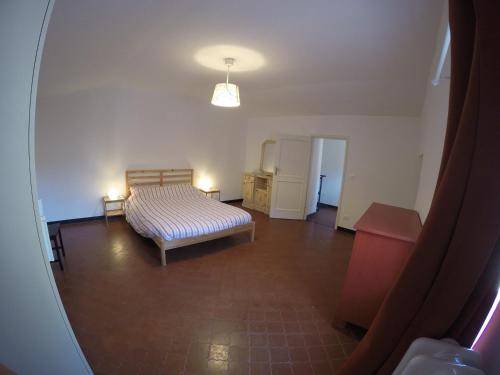 an empty room with a bed and a table at Case di Campo in Albenga