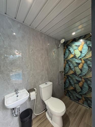 a bathroom with a toilet and a sink at The Barkly House Staycation in Biñan