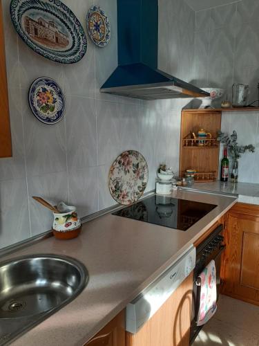 a kitchen with a sink and plates on the wall at Casa Rural Horizontes de la Mancha in El Toboso