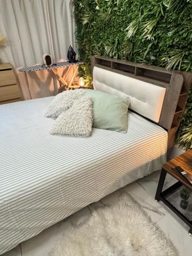 a bed with two pillows on top of it at Modern suite with jacuzzi in Toulon