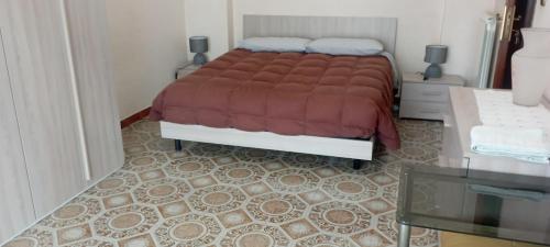 a bedroom with a bed with a red blanket at la casa di Titty con wi fi in Avellino