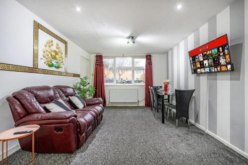 a living room with a leather couch and a table at RC10O Satisfying and Spacious stay in Central Station