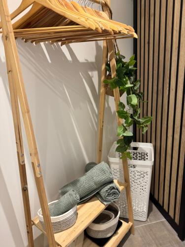 a wooden shelf with a plant on top of it at Modern suite with jacuzzi in Toulon