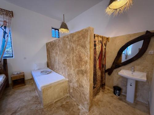 a bathroom with a tub and a sink in it at Carpe Diem Nungwi in Nungwi