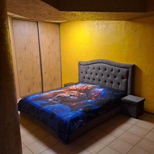 a bedroom with a bed in a yellow wall at Jacuzzi in Klaipėda