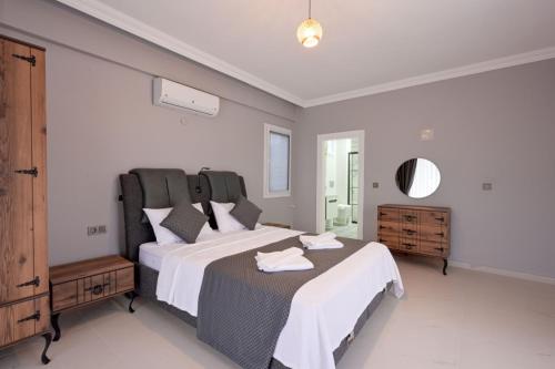 a bedroom with two beds and a mirror at Villa Egeden 2 in Fethiye