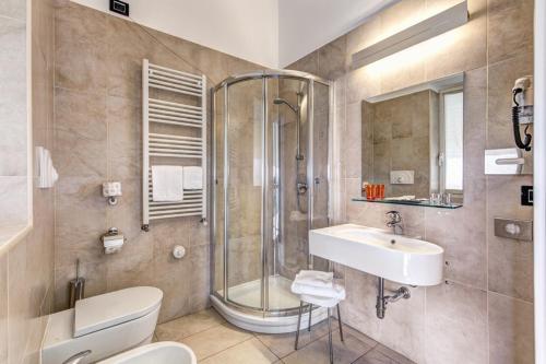 a bathroom with a shower and a sink and a toilet at HOTEL HMR RHO Milano in Rho