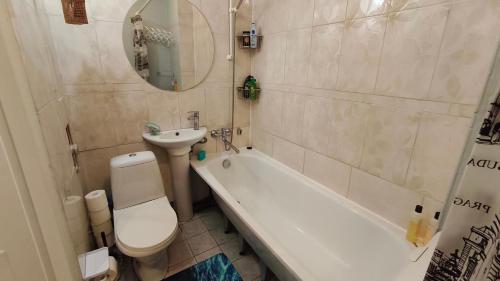 a bathroom with a toilet and a sink and a tub at Vilde Apartment in Tallinn