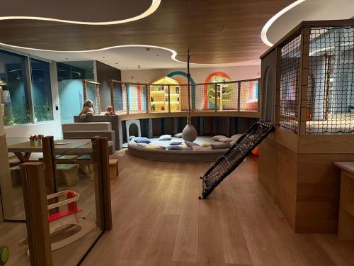 a living room with a slide in the middle of a room at Apartment with pool on Paseo Santa Lucia in Monterrey
