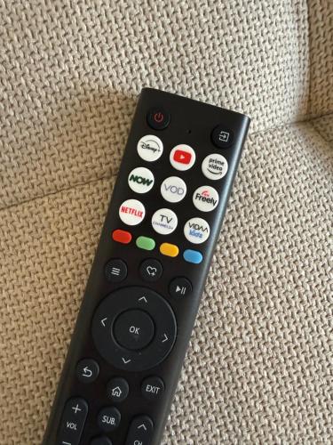 a remote control sitting on top of a couch at Deer Lodge in Glastonbury