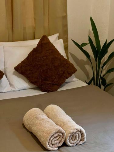 a pair of towels laying on a bed at Paians 2BR Home, across Cloud 9, General Luna in Catangnan